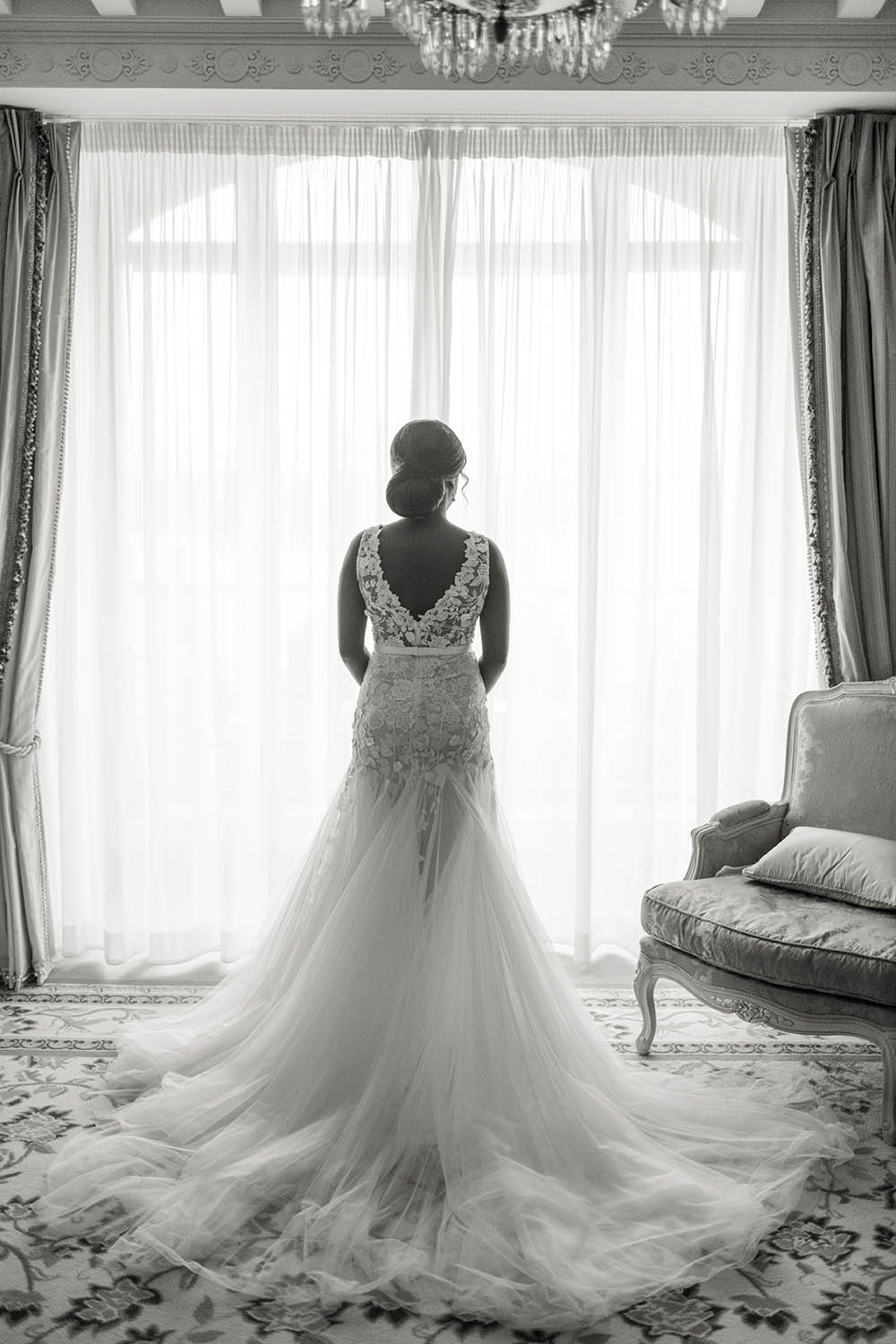 bride face to window with our wedding dress